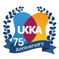 A blue badge logo celebrating the 75th Anniversary of the UKKA